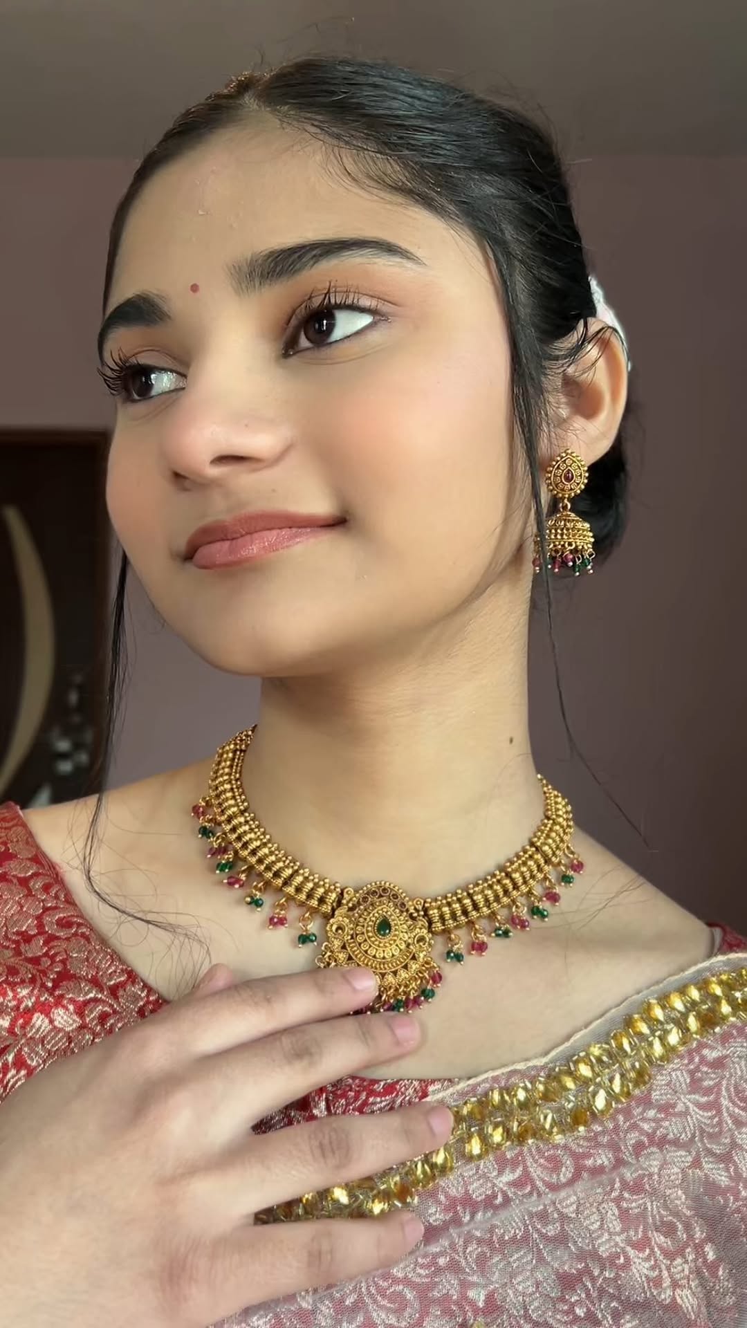Brass jewelry set worn by a model